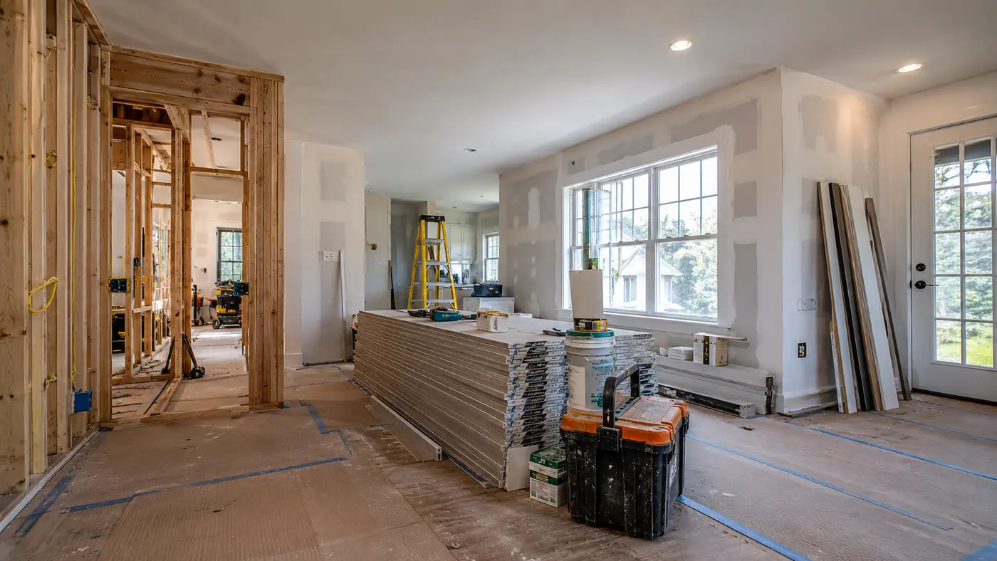 Concept rendering: full interior renovation in progress with wall framing and stacked drywall in Wilmington, DE